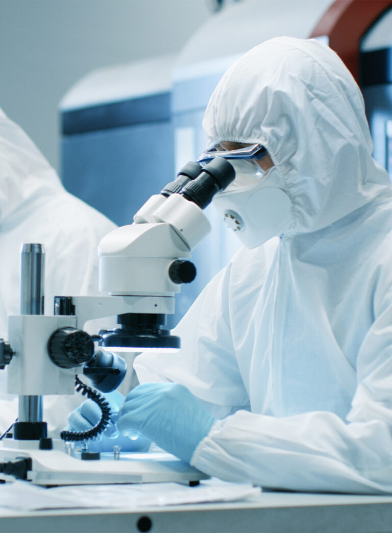 Cleanroom laboratory technician microscope analysis
